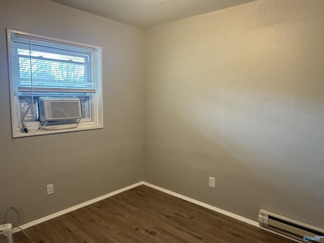 unfurnished room with baseboard heating, cooling unit, and dark hardwood / wood-style floors