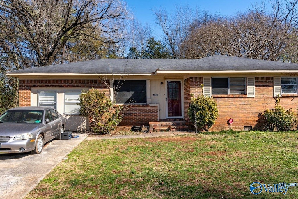 ranch-style house featuring a garage, brick siding, concrete driveway, crawl space, and a front yard