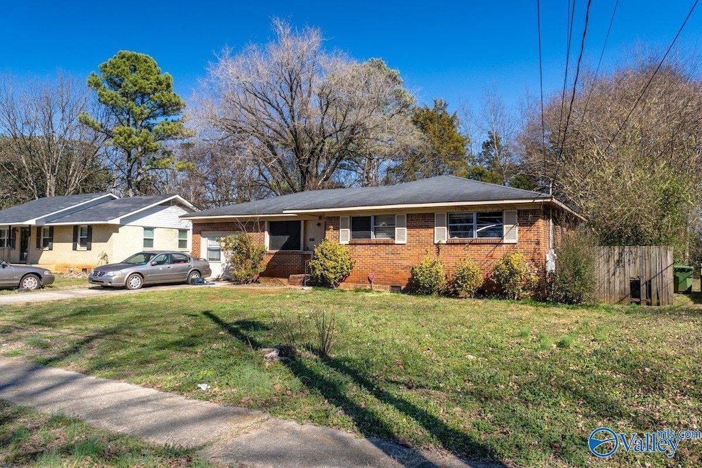 ranch-style house with crawl space, brick siding, and a front lawn