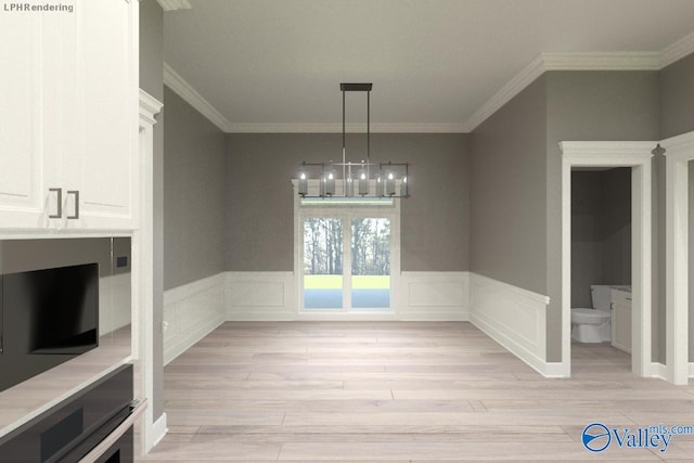 unfurnished dining area featuring crown molding, a chandelier, and light hardwood / wood-style flooring