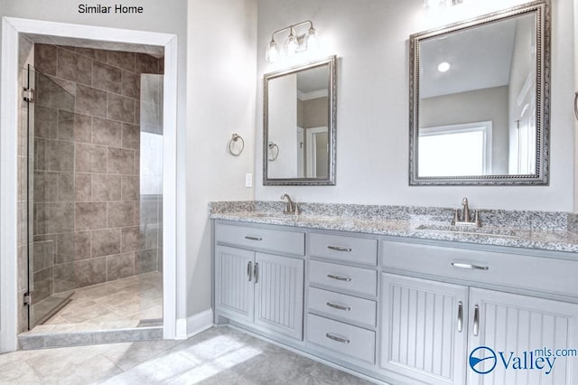 bathroom with vanity and a tile shower