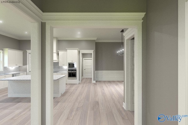 hallway with ornamental molding and light wood-type flooring