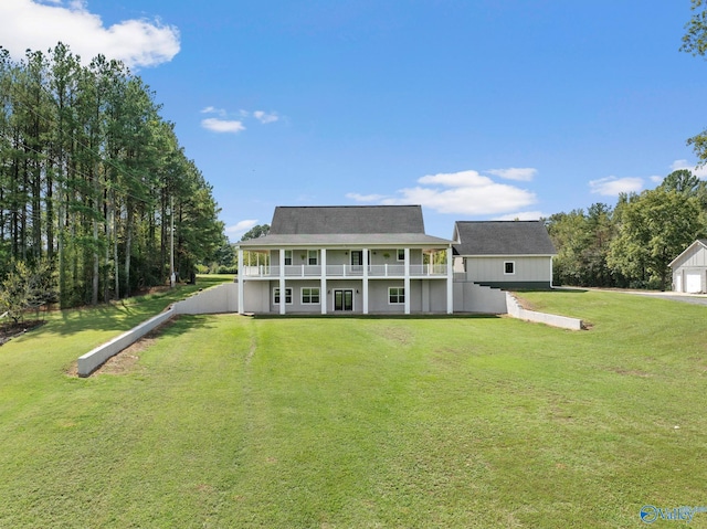 rear view of property with a lawn, a porch, and a garage