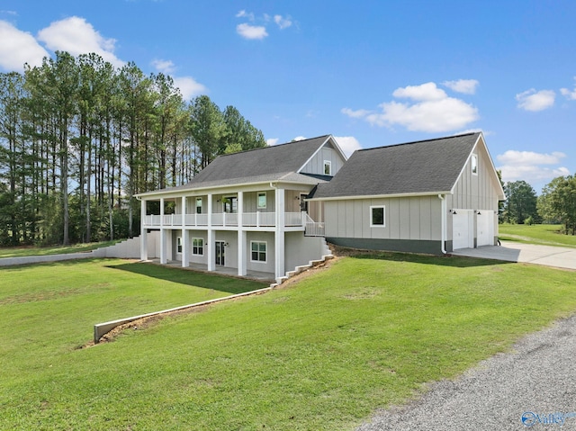 back of property featuring a balcony, a yard, and covered porch