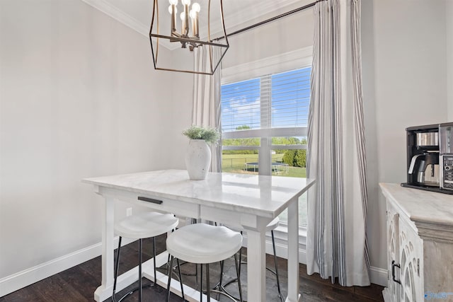 dining area with dark wood-style floors, baseboards, ornamental molding, and an inviting chandelier