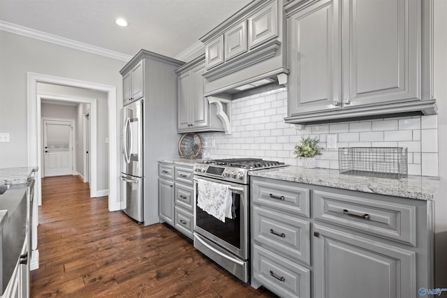 kitchen featuring gray cabinets, crown molding, tasteful backsplash, and stainless steel appliances