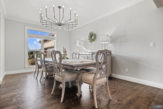 dining area with wood finished floors, baseboards, an inviting chandelier, and crown molding