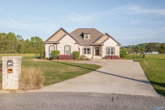 french country style house with brick siding, roof with shingles, and a front yard