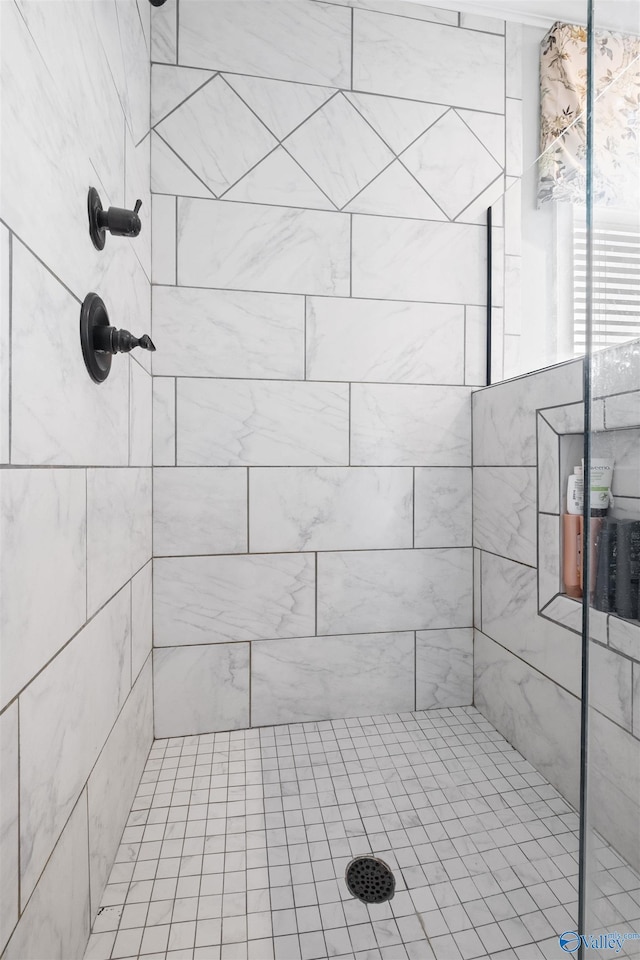 bathroom with a tile shower