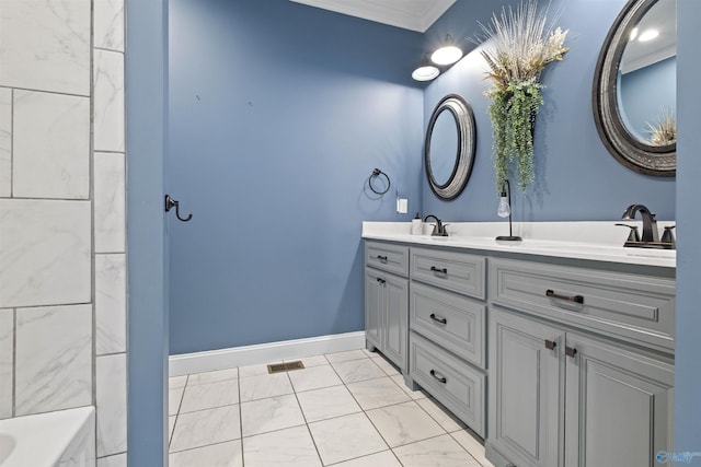 bathroom featuring marble finish floor, a sink, double vanity, and crown molding