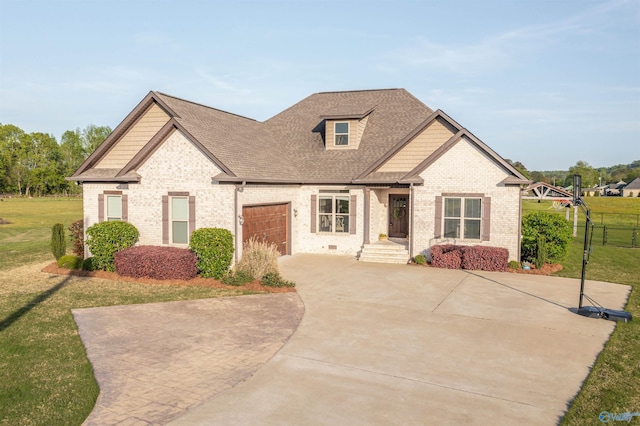 view of front facade with brick siding, an attached garage, a front yard, and driveway