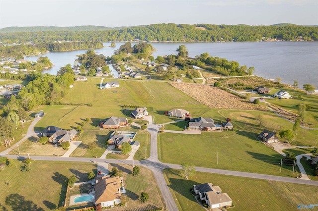 bird's eye view with a forest view and a water view