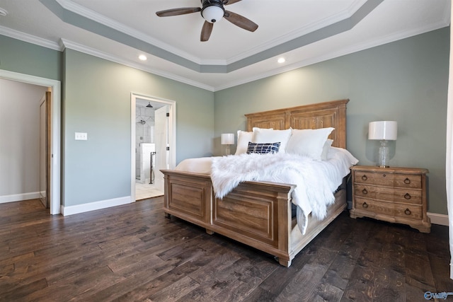 bedroom with dark wood finished floors, recessed lighting, ornamental molding, and a raised ceiling