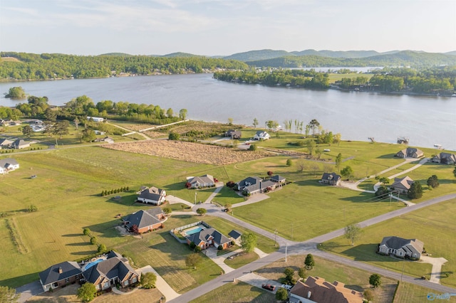 drone / aerial view featuring a water and mountain view