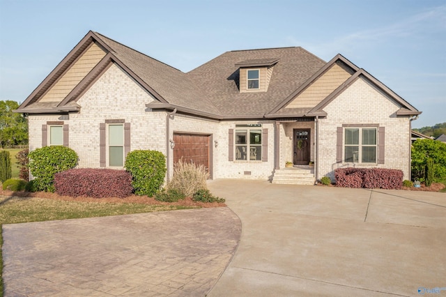 view of front facade with brick siding, driveway, a shingled roof, and a garage