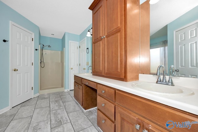 bathroom featuring tile patterned flooring, vanity, and walk in shower