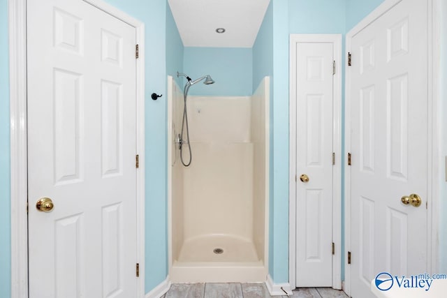 bathroom featuring walk in shower and tile patterned floors