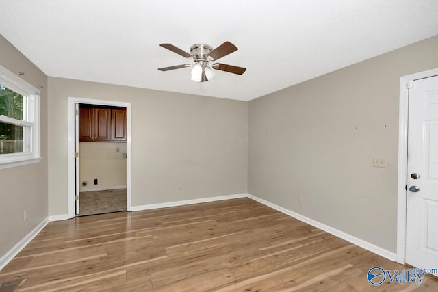 unfurnished bedroom with ceiling fan and light wood-type flooring