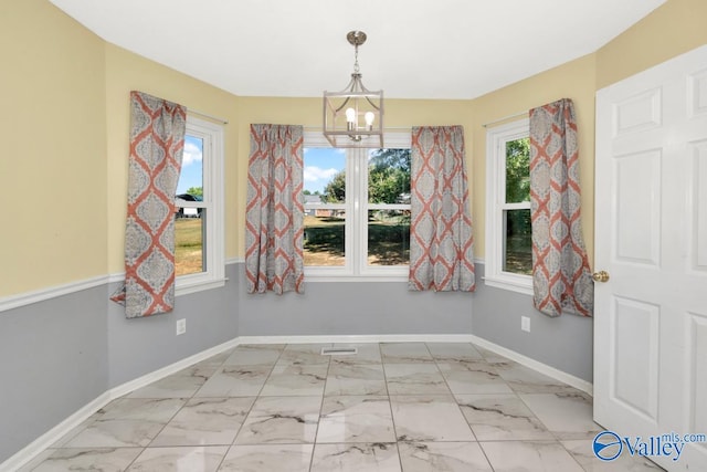 unfurnished dining area with light tile patterned floors and a notable chandelier