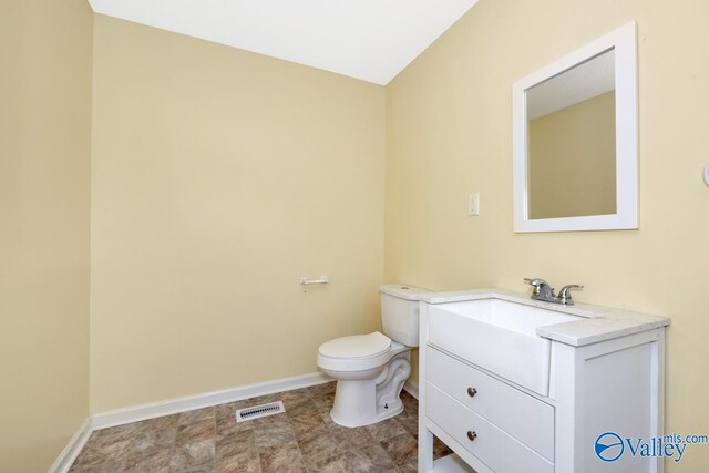 bathroom with tile patterned flooring, vanity, and toilet