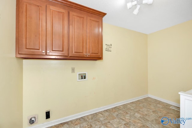 laundry area with light tile patterned floors, hookup for a washing machine, and cabinets