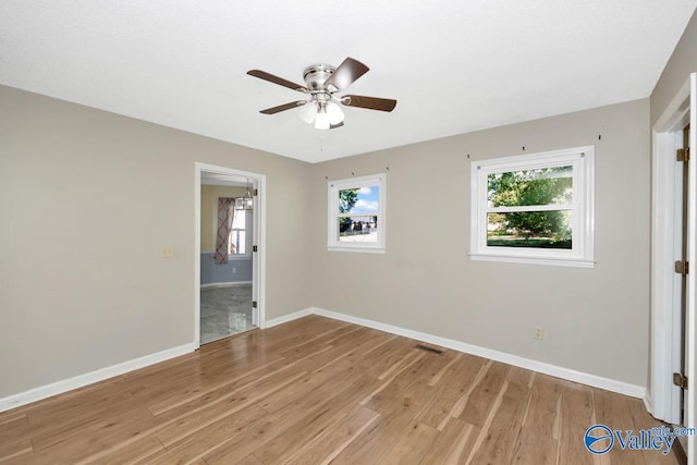 spare room featuring ceiling fan and hardwood / wood-style floors