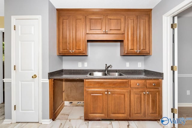 kitchen featuring light tile patterned floors and sink