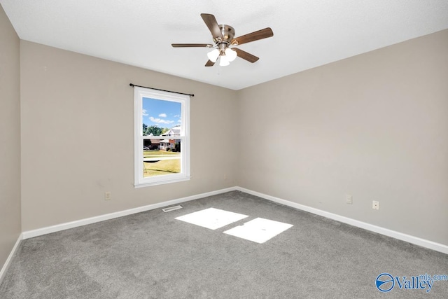 carpeted empty room featuring ceiling fan