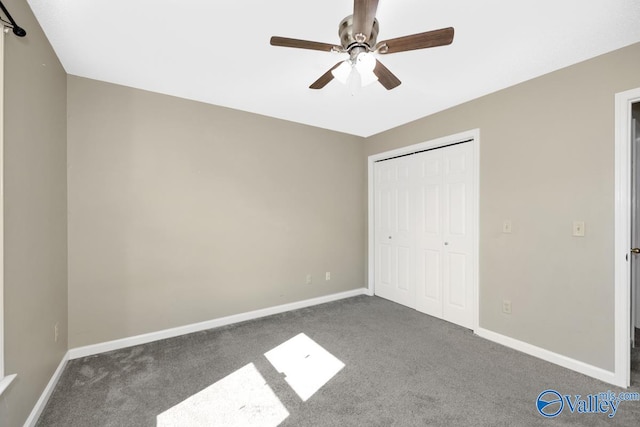 unfurnished bedroom with ceiling fan, a closet, and carpet