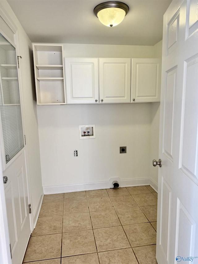 washroom featuring hookup for a washing machine, cabinet space, hookup for an electric dryer, light tile patterned flooring, and baseboards