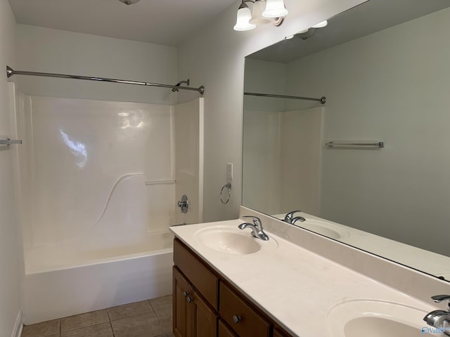 bathroom featuring double vanity, a sink, and tile patterned floors