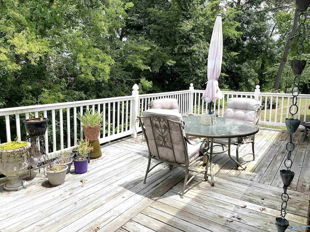 wooden terrace featuring outdoor dining area