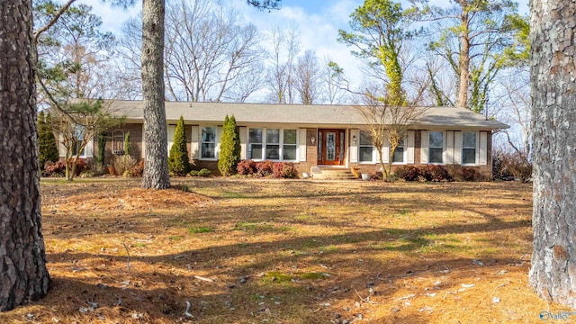 ranch-style house featuring brick siding