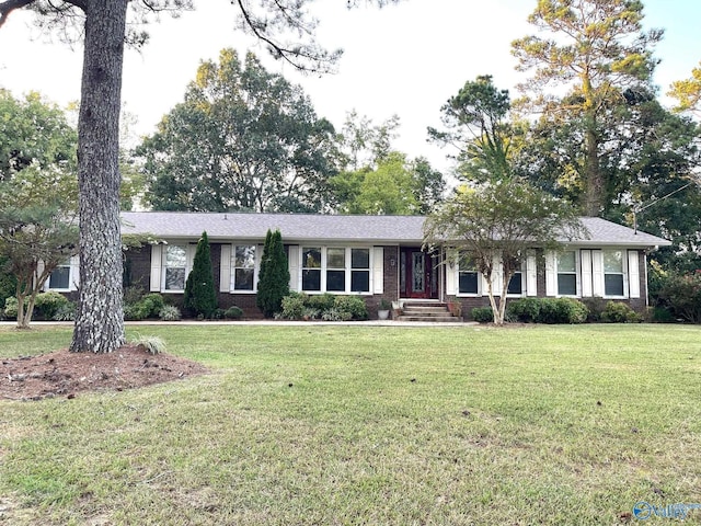 single story home featuring brick siding and a front yard
