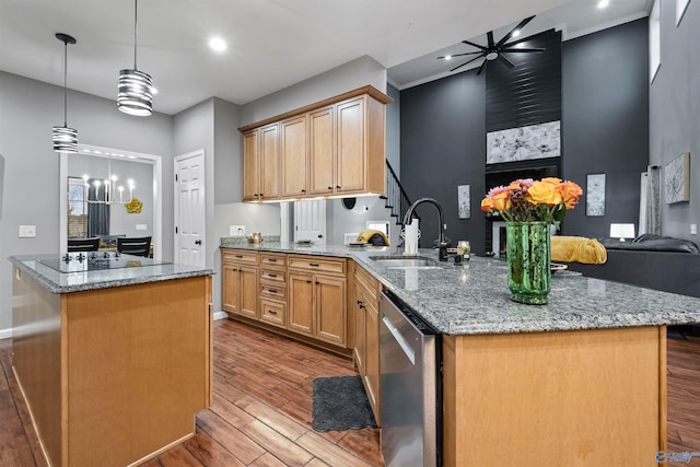 kitchen with dishwasher, sink, decorative light fixtures, a kitchen island, and ceiling fan with notable chandelier