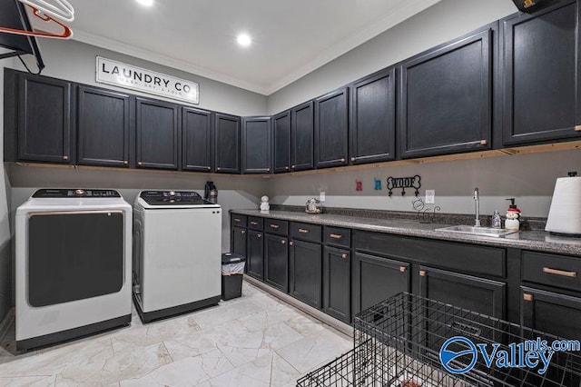 laundry area featuring cabinets, washing machine and dryer, ornamental molding, and sink