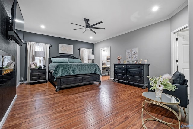 bedroom with ceiling fan, dark hardwood / wood-style flooring, and crown molding