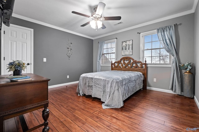 bedroom featuring ceiling fan, ornamental molding, and multiple windows