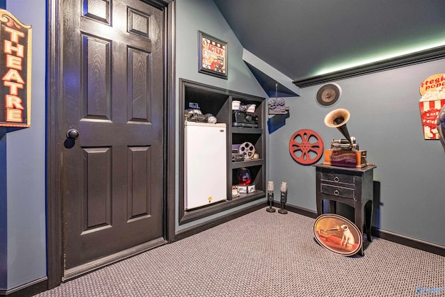 game room featuring carpet and vaulted ceiling