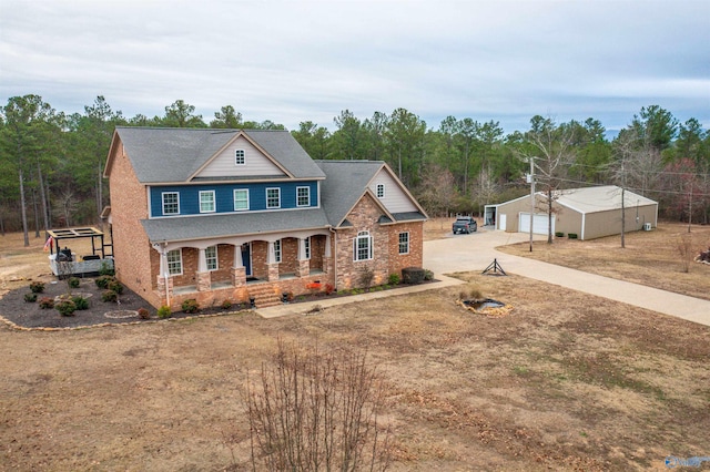 view of front of home with an outbuilding, a garage, and covered porch