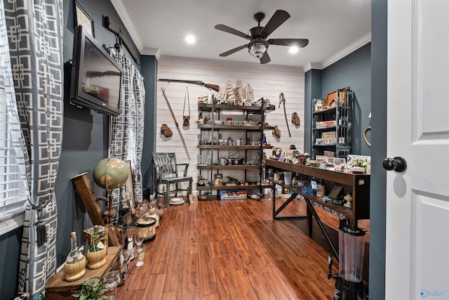 office space featuring hardwood / wood-style floors, ceiling fan, and ornamental molding