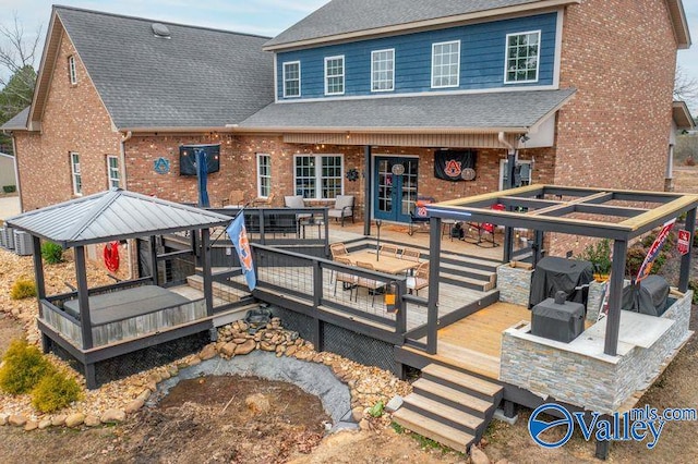 rear view of property featuring a wooden deck