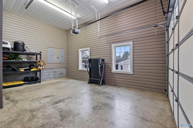 garage with a garage door opener and wood walls