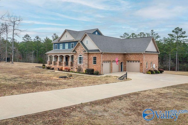 view of front of home featuring covered porch and a garage