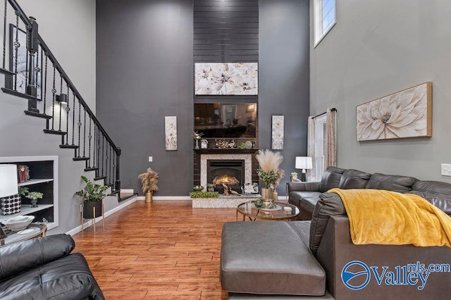 living room featuring hardwood / wood-style floors and a towering ceiling