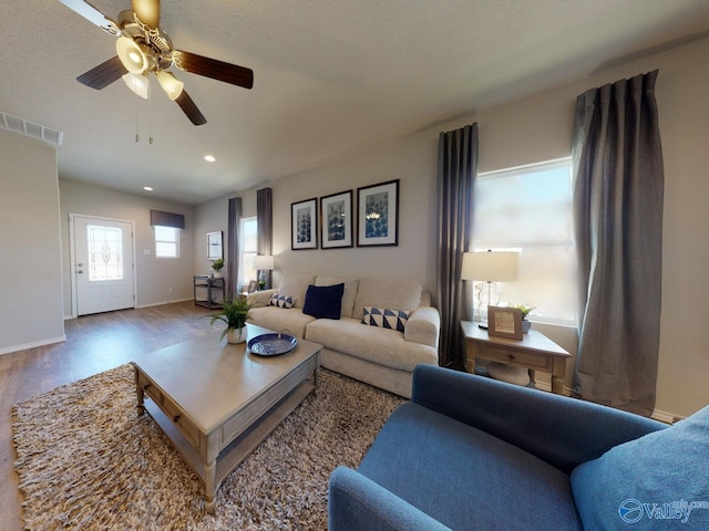 living room with wood-type flooring and ceiling fan