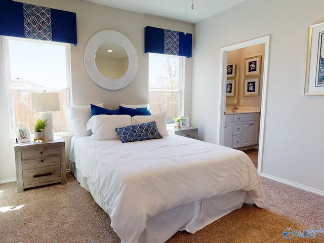 bedroom with light carpet and ensuite bath