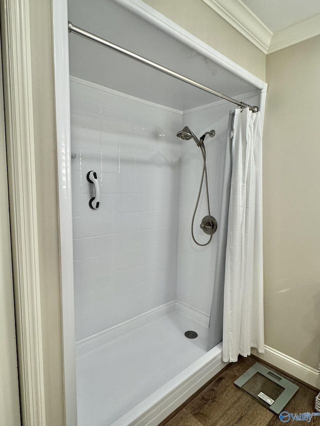 bathroom with crown molding and curtained shower