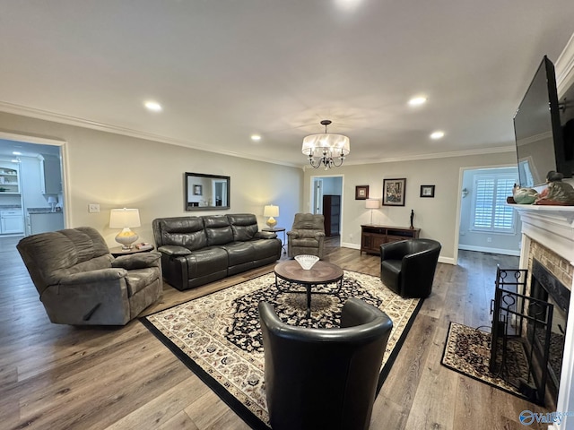 living room with hardwood / wood-style floors, a chandelier, and crown molding