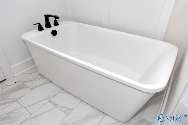 4 Sable Creek Ct, Gurley, AL 35748 - bathroom featuring a soaking tub, marble finish floor, and baseboards